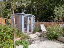 A garden shed surrounded by flowers at The Corner House in Ufford near Woodbridge