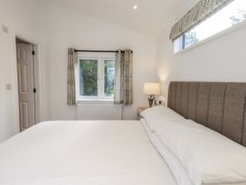 A bedroom with a bed and lamp at Lakeside Lodge near Bowland Lakes Leisure Village