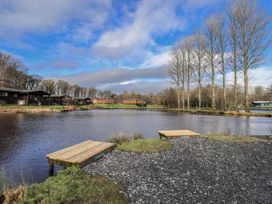 An outdoor space with water and wooden platforms at Lakeside Lodge Bowland Lakes Leisure Village near Garstang