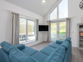 A living room with a sofa and television at Moranedd Bach in Holyhead