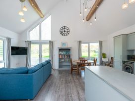 A living room with a sofa and bookshelf at Moranedd Bach in Holyhead