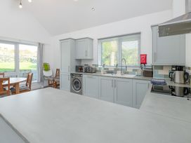 A kitchen with table and chairs at Moranedd Bach in Holyhead