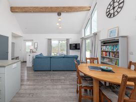 A living room with a sofa and dining table at Moranedd Bach in Holyhead