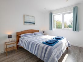 A bedroom with a bed and bedside table at Moranedd Bach in Holyhead