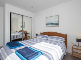 A bedroom with a bed and bedside table at Moranedd Bach in Holyhead