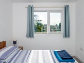 A bedroom with a bed and blue towels at Moranedd Bach in Holyhead