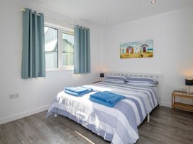 A bedroom with a bed and bedside tables at Moranedd Bach in Holyhead