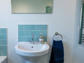 A bathroom with a sink and mirror at Moranedd Bach in Holyhead