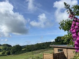 A view of a wooden building and landscape at Foxglove in Higher Wambrook near Chard
