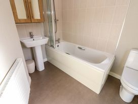 A bathroom with a bathtub shower sink toilet and radiator at Dragonfly in Tunstall near Hipswell
