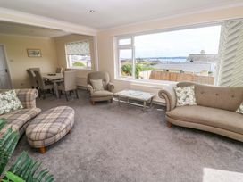 A living room with a sofa and a coffee table at Karenza in Penzance
