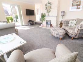 A living room with a TV and seating at Karenza in Penzance