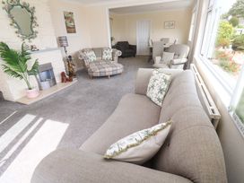 A living room with a sofa and armchair at Karenza in Penzance