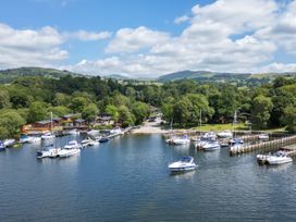 A marina with boats and houses near water at Dovedale Lodge White Cross Bay Holiday Park near Troutbeck Bridge