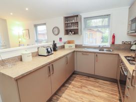A kitchen with appliances including a toaster and kettle at Dovedale Lodge Bowness 70, White Cross Bay near Windermere