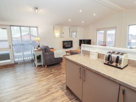A living room with sofa and television at Dovedale Lodge Bowness 70, White Cross Bay near Windermere