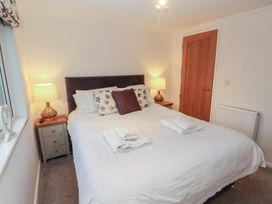 A bedroom with a bed and lamp at Dovedale Lodge Bowness 70, White Cross Bay near Windermere