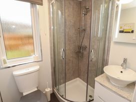 A bathroom with a shower, toilet, and sink at Dovedale Lodge Bowness 70, White Cross Bay near Windermere