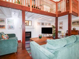 A living room with a sofa and television at Rosemaddon in Crantock