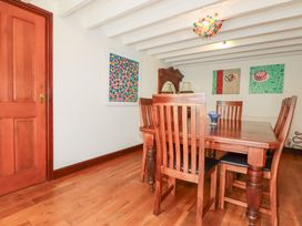 A dining room with a table and chairs at Rosemaddon in Crantock