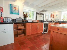 A kitchen with cabinets, oven and sink at Rosemaddon in Crantock