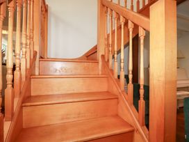 A wooden staircase with a handrail at Rosemaddon in Crantock