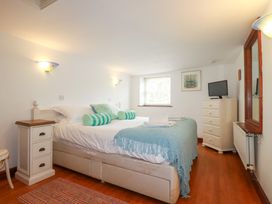 A bedroom with a bed and chest of drawers at Rosemaddon in Crantock