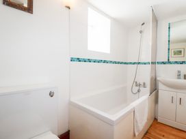 A bathroom with a sink, shower, bathtub and toilet at Rosemaddon in Crantock