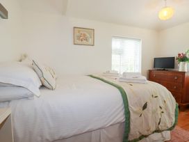 A bedroom with a bed and television at Rosemaddon in Crantock