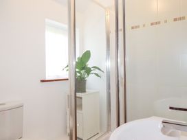 A bathroom with a shower and plant at Rosemaddon Crantock