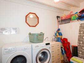 A laundry room with a washing machine and dryer at Rosemaddon in Crantock