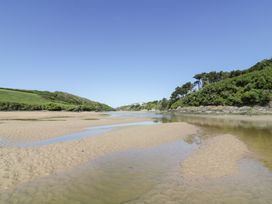 A river with sandbanks and greenery at Rosemaddon in Crantock
