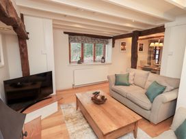 A living room with a sofa and coffee table at Jasmine Cottage Thornthwaite