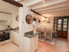 A kitchen with dining area and door at Jasmine Cottage Thornthwaite