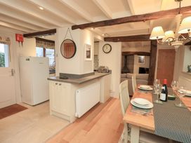 A kitchen with dining area and appliances at Jasmine Cottage Thornthwaite
