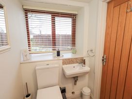 A bathroom with a toilet and sink at Jasmine Cottage in Thornthwaite