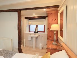 A bedroom with a sink and lamp at Jasmine Cottage Thornthwaite
