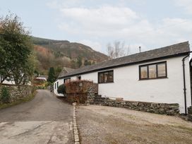 A house on a road near mountains at Jasmine Cottage in Thornthwaite