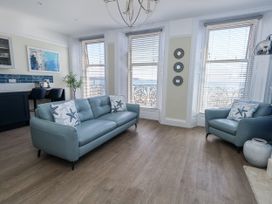 A living room with a sofa and armchair at Apartment 1 in Weymouth