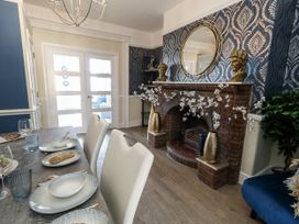 A dining room with a table set for meals at Apartment 1 Weymouth