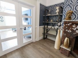 An entryway with a door, shelf, and vase at Apartment 1 in Weymouth