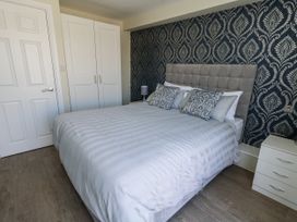 A bedroom with a bed and wardrobe at Apartment 1 in Weymouth