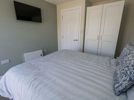 A bedroom with a bed and wardrobe at Apartment 1 in Weymouth