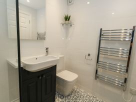 A bathroom with a wash basin and toilet at Apartment 1 in Weymouth