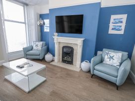 A living room with a television and fireplace at Vista Mare 1 Weymouth