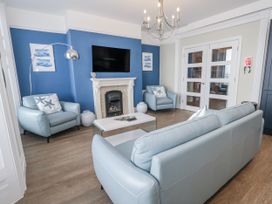 A living room with a sofa and armchairs at Vista Mare 1 in Weymouth
