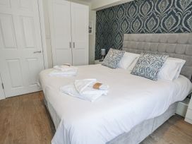 A bedroom with a bed and wardrobe at Vista Mare 1 Weymouth