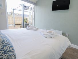 A bedroom with a bed and television at Vista Mare 1 in Weymouth