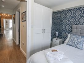 A bedroom with a bed and wardrobe at Vista Mare 1 in Weymouth