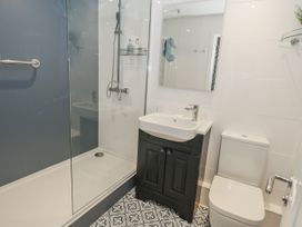 A bathroom with a shower, sink, and toilet at Vista Mare 1 Weymouth